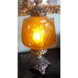 A gilt metal table lamp with amber glass shade, 60cm high.