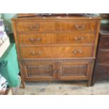 A mahogany chest with three long drawers over a cupboard base, 105cm wide.