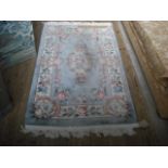 A Chinese rug with pale blue ground and ivory border, 156 x 91cm.