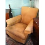 An Edwardian fully upholstered armchair on cabriole legs.