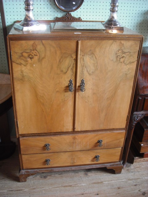 A 1930's walnut compactum on bracket feet.