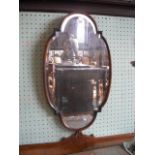 A wall mirror with oval shaped bevelled plate in a beech wood frame, 71 x 41cm.