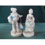 A pair of Continental porcelain figures, modelled as a dandy in 18th century costume, together with