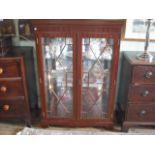 A reproduction mahogany glazed dwarf bookcase, 87cm wide.