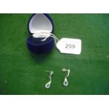 A pair of white metal ear pendants set w