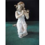 A Lladro figure modelled as a seated fem