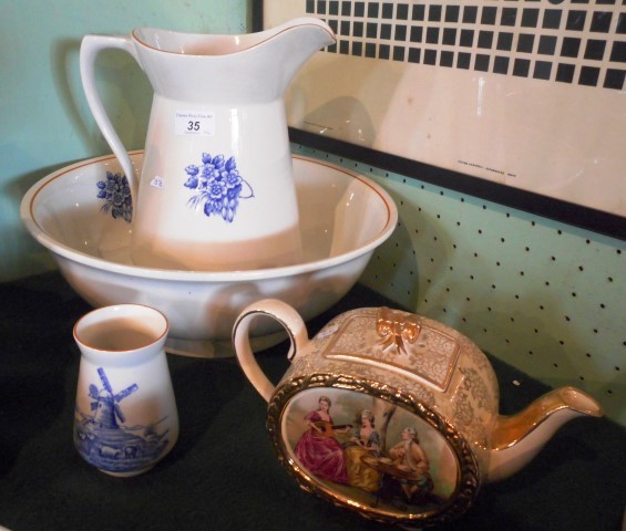 A ceramic washbowl and jug, each decorated with blue transfer printed flowers,
