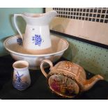 A ceramic washbowl and jug, each decorated with blue transfer printed flowers,