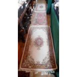 Three modern Chinese rugs, two matching, all with floral decoration, 77 x 140cm & 52 x 122cm.