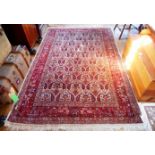 A hand made Iranian woollen Malayer carpet, the central panel decorated with Paisley-style motifs,