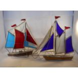 Two metal and glass sailing boats, the tallest 23cm.