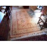 A Pakistan 100% wool pile carpet, the central panel decorated with stylized floral and leaf forms,