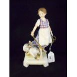A Continental figurine of a girl herding