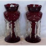 A pair of Victorian cranberry clear glass table lustres, 33cm tall.