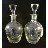 A pair of etched glass spirit decanters of bulbous form,