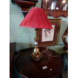 A brass candlestick formed table lamp on