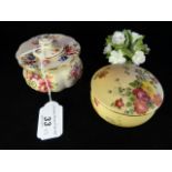 A Royal Worcester blush ivory lidded pot, decorated with hand painted floral spray,
