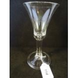 A mid-18th century wine glass, with bell shaped bowl on a columnar stem with folded foot, 18.