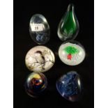 Six glass paperweights of varying form, all unmarked.