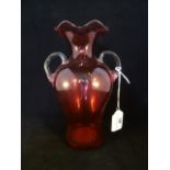 A Victorian twin handled cranberry glass vase, having wavy rim over the body of waisted form, 21.