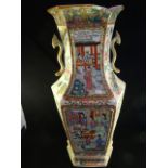 A 19th century Cantonese vase of two handled hexagonal shape, profusely decorated with figures,