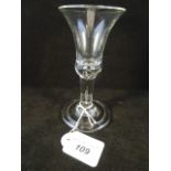 A mid-18th century wine glass, plain,