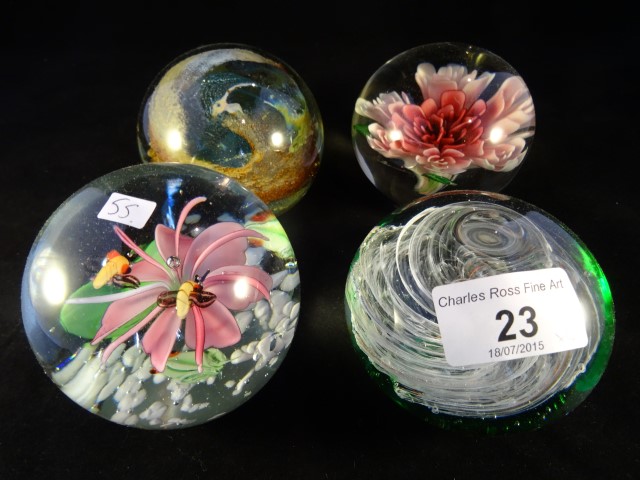 An Isle of Wight glass paperweight, together with three other similar.