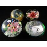 An Isle of Wight glass paperweight, together with three other similar.