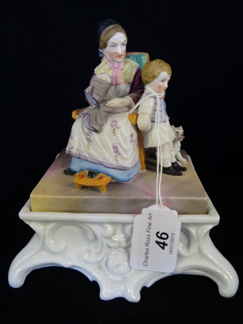 A Continental ceramic inkstand, circa 1890, having a bisque figural group to cover,