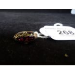 A yellow metal ring set with twin rubies