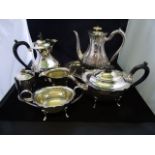 A silver plated teapot with ebony loop h