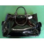 A ladies Anya Hindmarch black patent lea