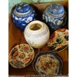 A pair of blue and white Chinese ginger jars, decorated with prunus blossom, a ginger jar with