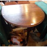 A 20th century oak gate leg table on rope twist supports, 102cm extended.