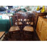 A set of four early 20th century oak dining chairs (three standard, one carver),