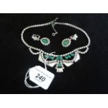 A decorative necklace and earrings set, featuring Art Deco-style green and white stones. Condition