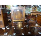 An Edwardian mahogany square occasional two tiered table on turned supports.