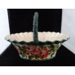 A large early 20th century Wemyss ceramic basket, having rose decoration within green border,