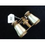 A pair of brass opera glasses, the barrels formed of mother of pearl,