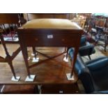 An Edwardian posted piano stool, having inlaid decoration, united by X-stretcher.