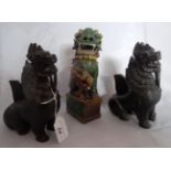 A pair of carved hardwood Chinese incense holders modelled as Dogs of Fo,