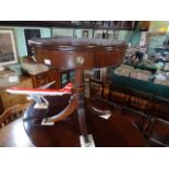 A reproduction mahogany single drawer drum table on four splayed supports.