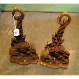 A pair of Victorian wrought iron door stops cast as stylized lions, 37cm.