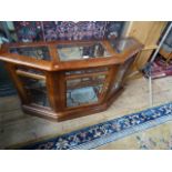 A reproduction glazed top display cabinet, with angled front flanking single drawer, 121cm wide.