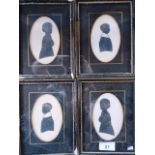 A collection of framed and glazed silhouettes of two children,