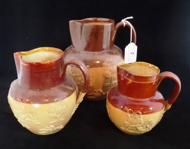 Three Doulton Lambeth salt glazed stoneware Harvest jugs, each with typical sprig decoration, the