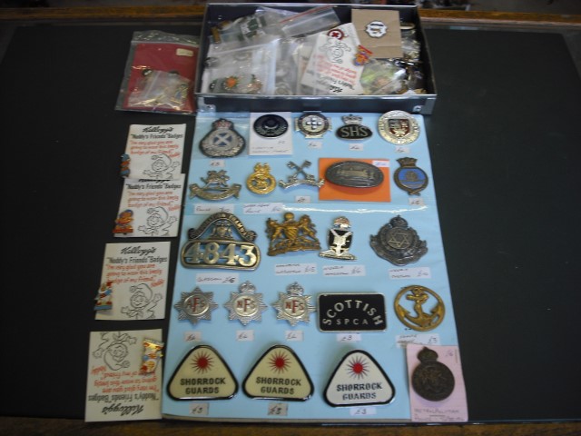 A large quantity of enamel and other badges, to include: transport, military and novelty examples.