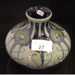 A Moorcroft squat and bulbous vase, having stylized peacock feather decoration,