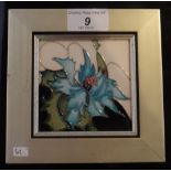 A Moorcroft framed square tile in the Sea Holly design, impressed and painted marks to reverse,