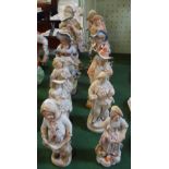 Twelve Continental bisque and ceramic figurines, various sizes.